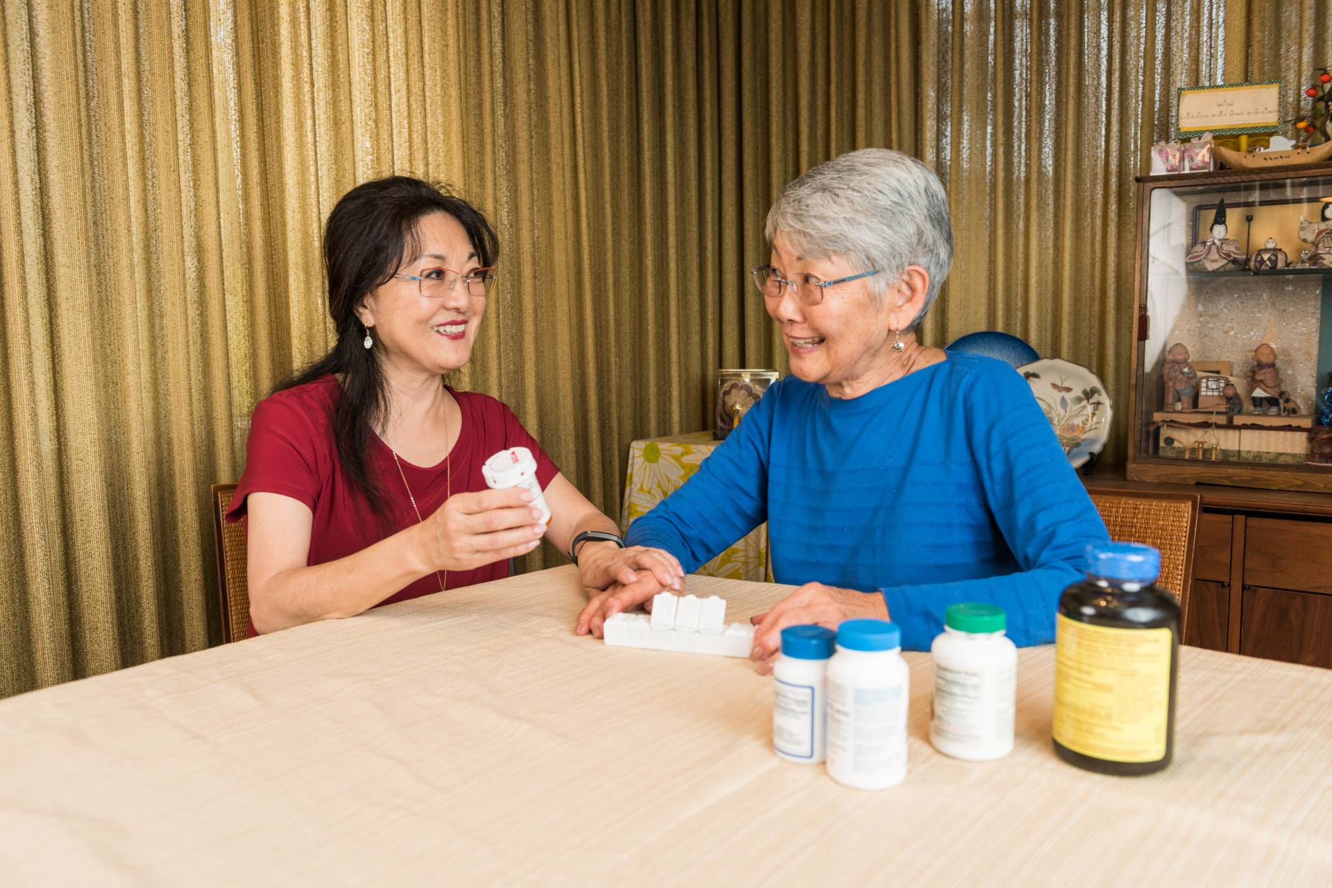 older adult conversing with caregiver on medication